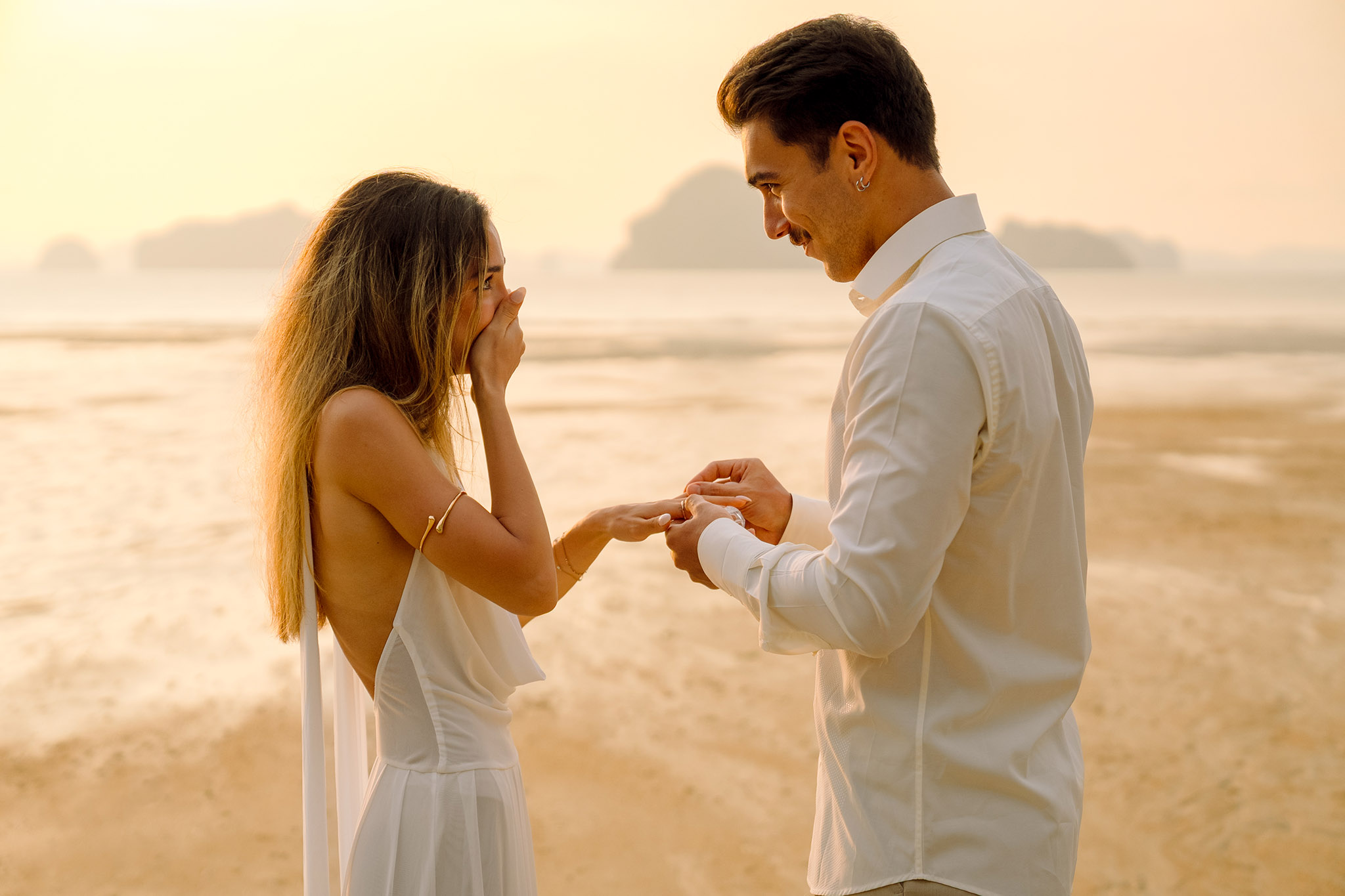 A couple celebrating their engagement at sunset in Krabi