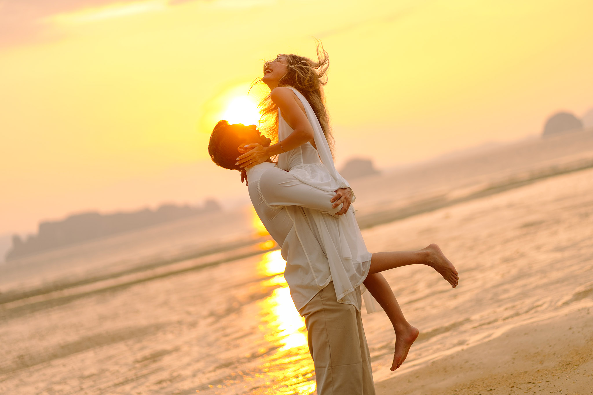 A couple celebrating their engagement at sunset in Krabi
